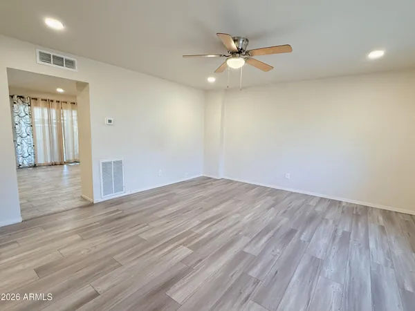 wooden floor in an empty room with a window
