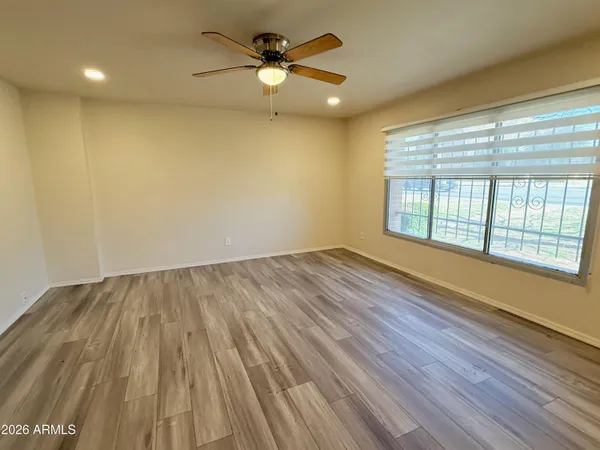 wooden floor in an empty room with a window
