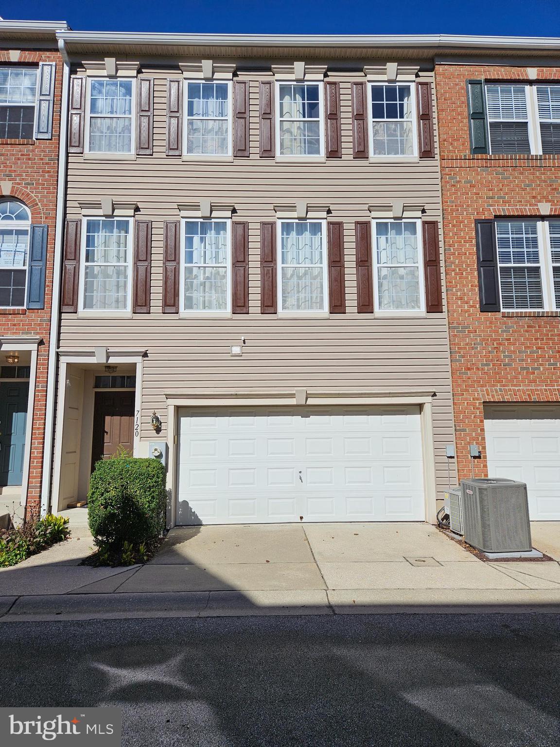 a front view of a building with a parking area