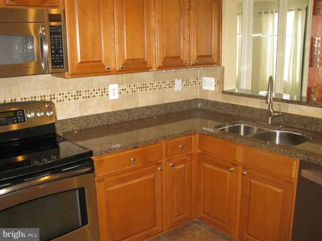 a view of a livingroom with wooden floor and a flat screen tv