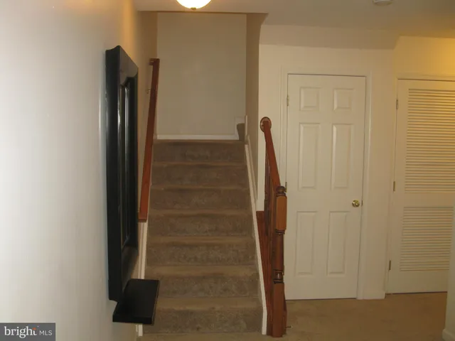 a room with water heater and a cabinets