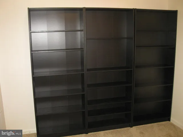 a view of an empty room with a fireplace