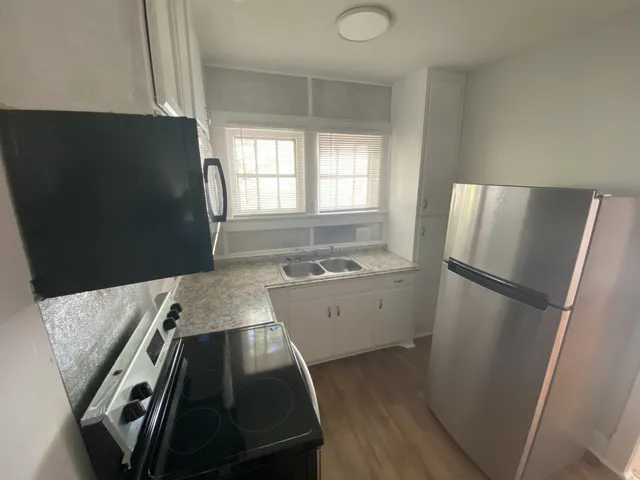 a kitchen with a refrigerator and a stove