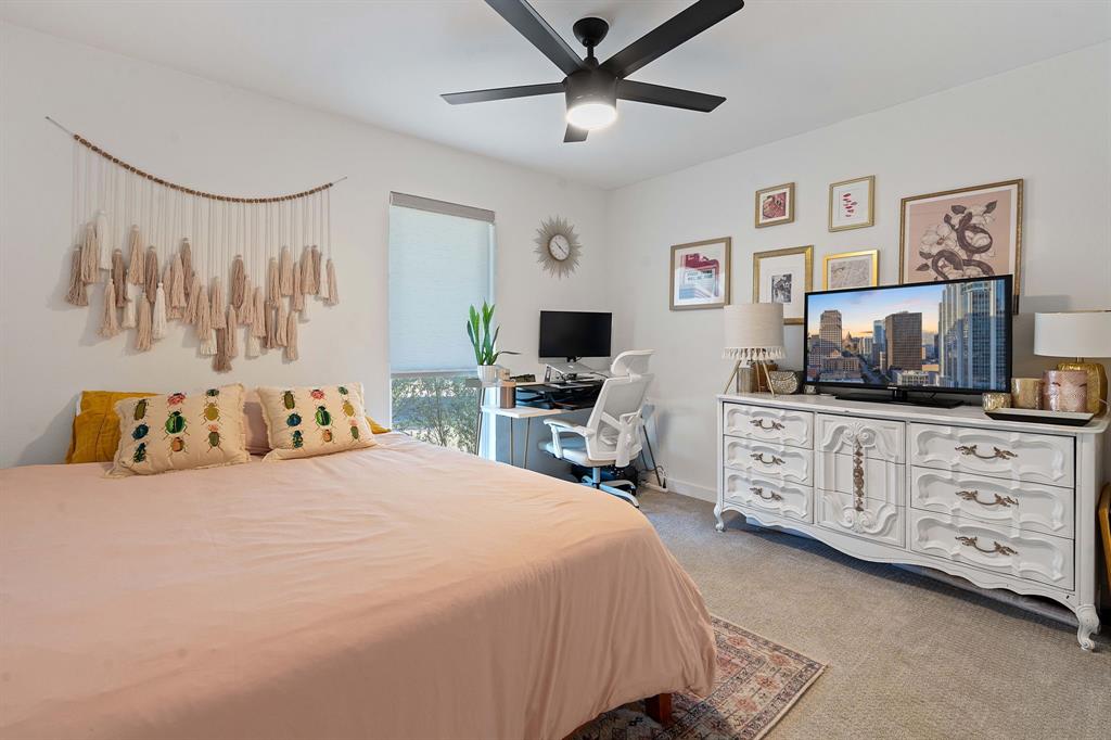 4902 Carsonhill Drive Austin, TX 78723 - Photo 12 of 19 Bedroom with light carpet, a ceiling fan, and a desk