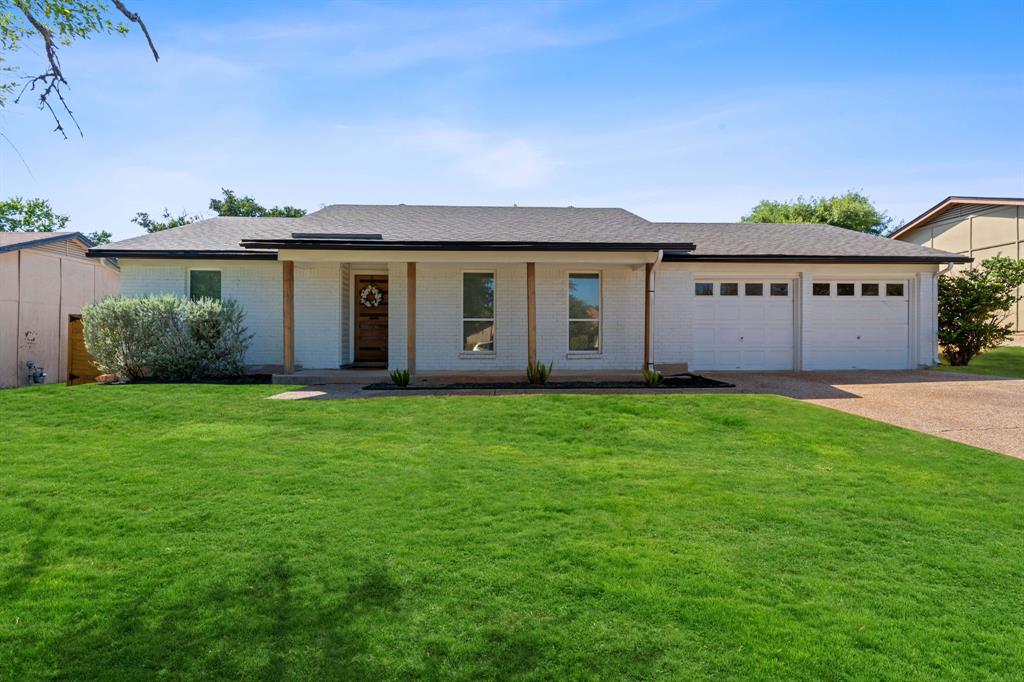 4902 Carsonhill Drive Austin, TX 78723 - Photo 2 of 19 Single story home with a porch, brick siding, a front lawn, and driveway