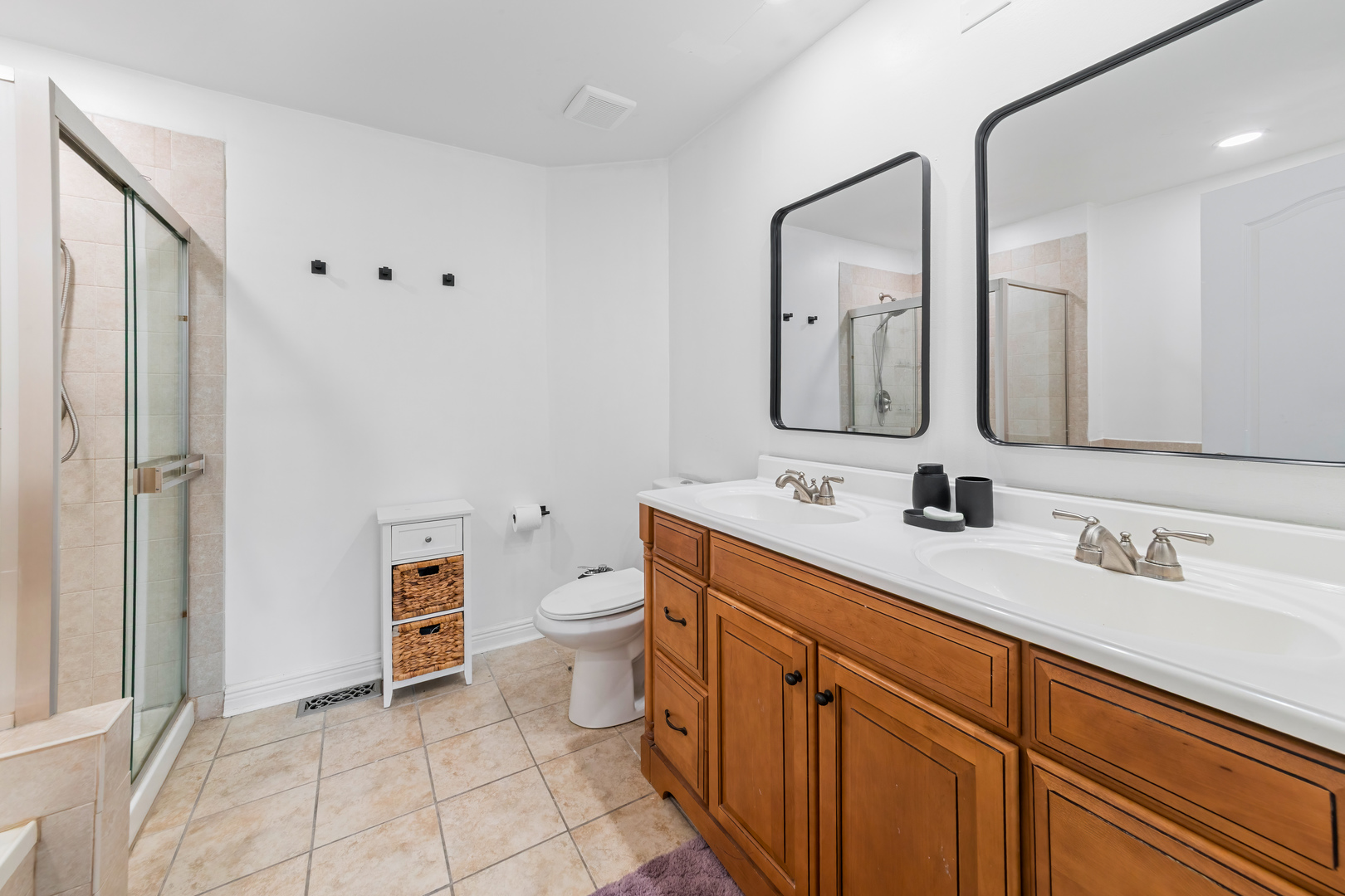2140 Seaver Lane Hoffman Estates, IL 60169 - Photo 13 of 25 a bathroom with a toilet sink double vanity and mirror