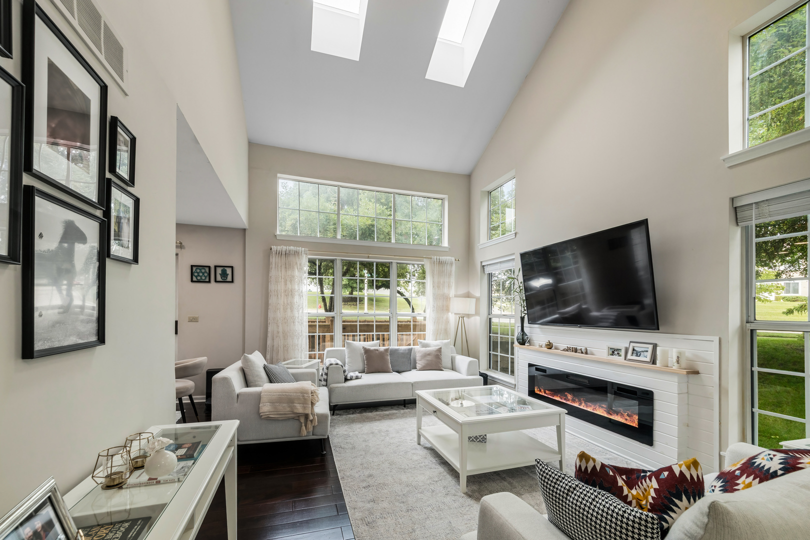 2140 Seaver Lane Hoffman Estates, IL 60169 - Photo 18 of 25 a living room with furniture a flat screen tv a window and a fireplace