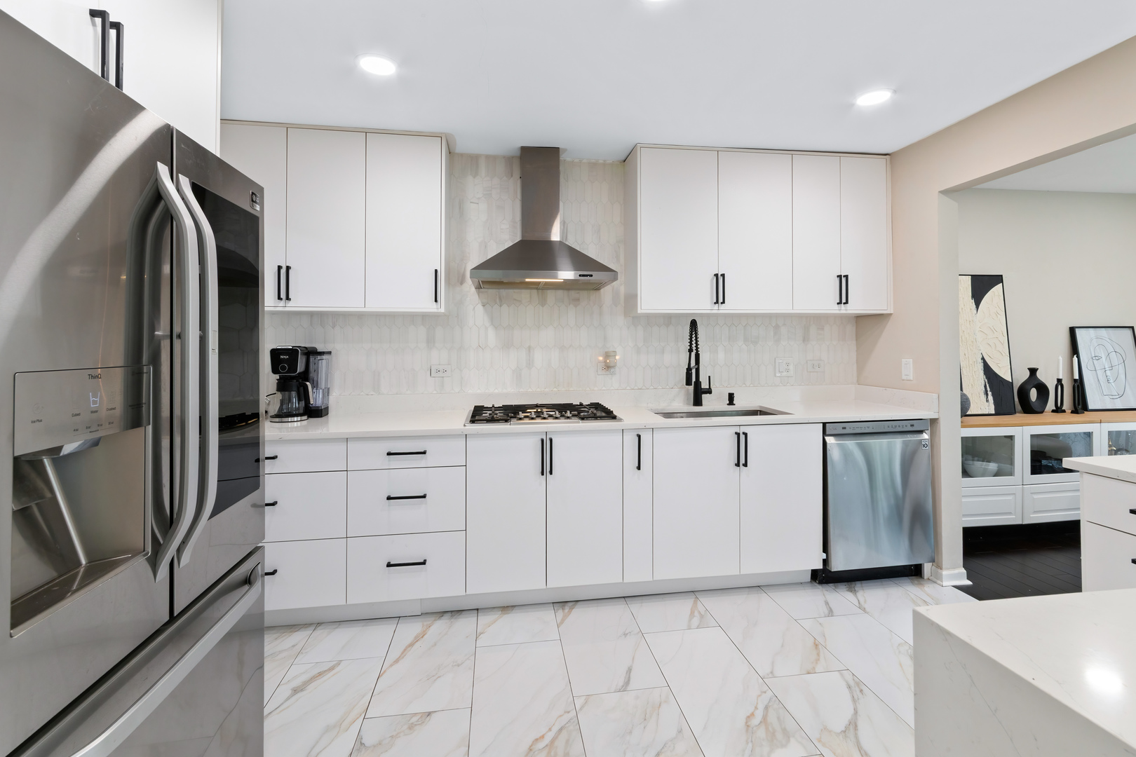 2140 Seaver Lane Hoffman Estates, IL 60169 - Photo 9 of 25 a kitchen with white cabinets and stainless steel appliances