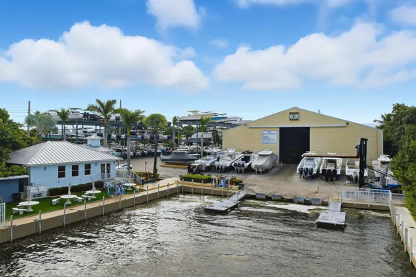 an aerial view of a house with swimming pool and furniture