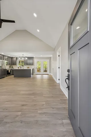 a kitchen with stainless steel appliances kitchen island granite countertop a refrigerator and a sink