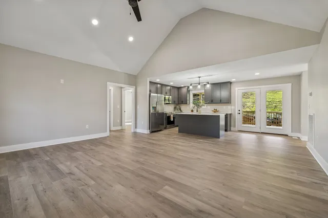 a kitchen with kitchen island a sink stainless steel appliances and cabinets