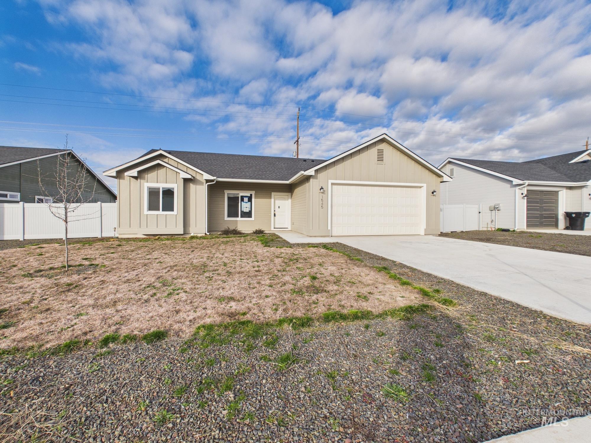 1545 Trail Way Weiser, ID 83672 - Photo 1 of 50 Ranch-style home featuring board and batten siding, a garage, concrete driveway, and roof with shingles