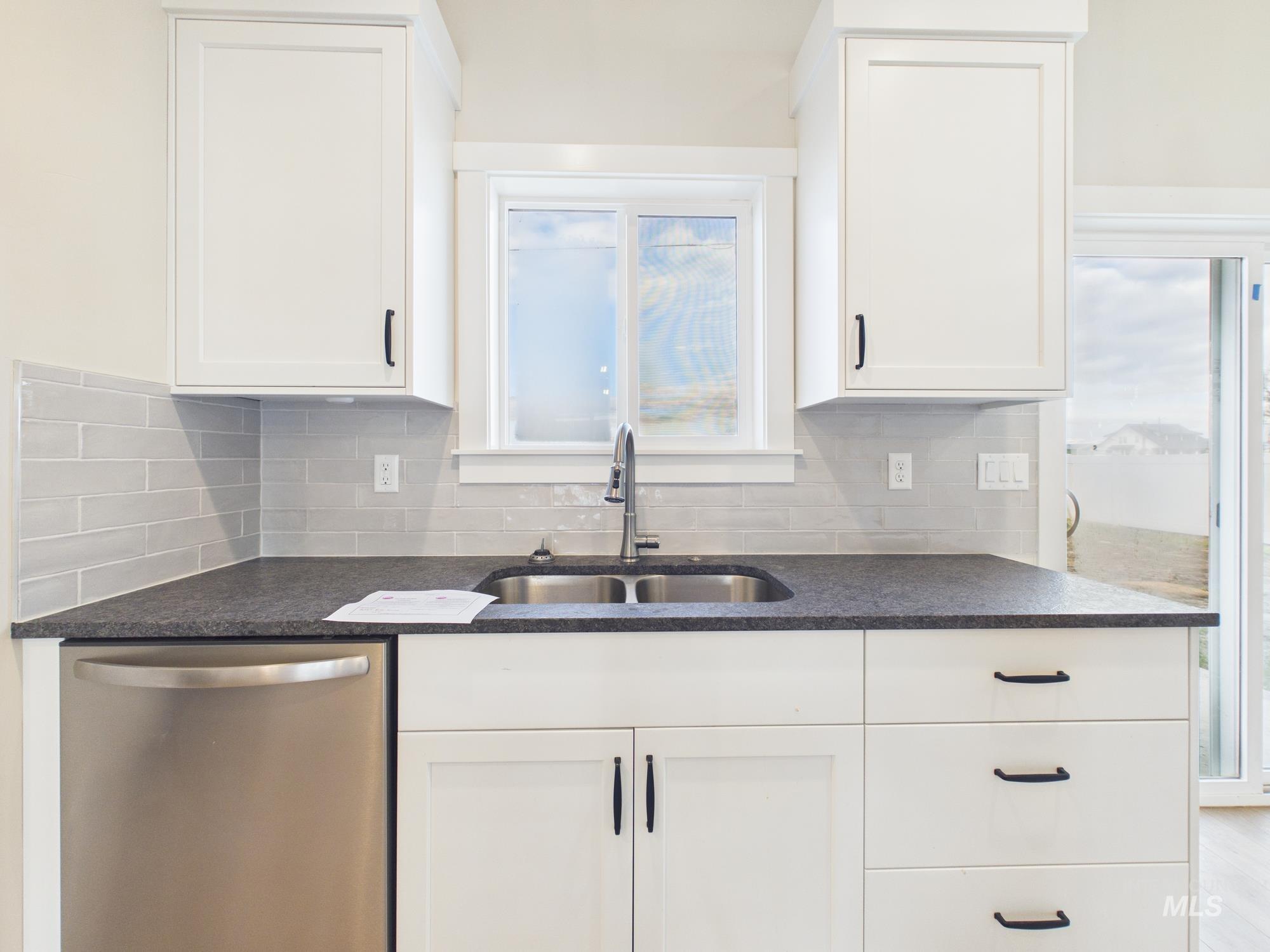 1545 Trail Way Weiser, ID 83672 - Photo 11 of 50 Kitchen featuring healthy amount of natural light, dishwasher, and white cabinetry