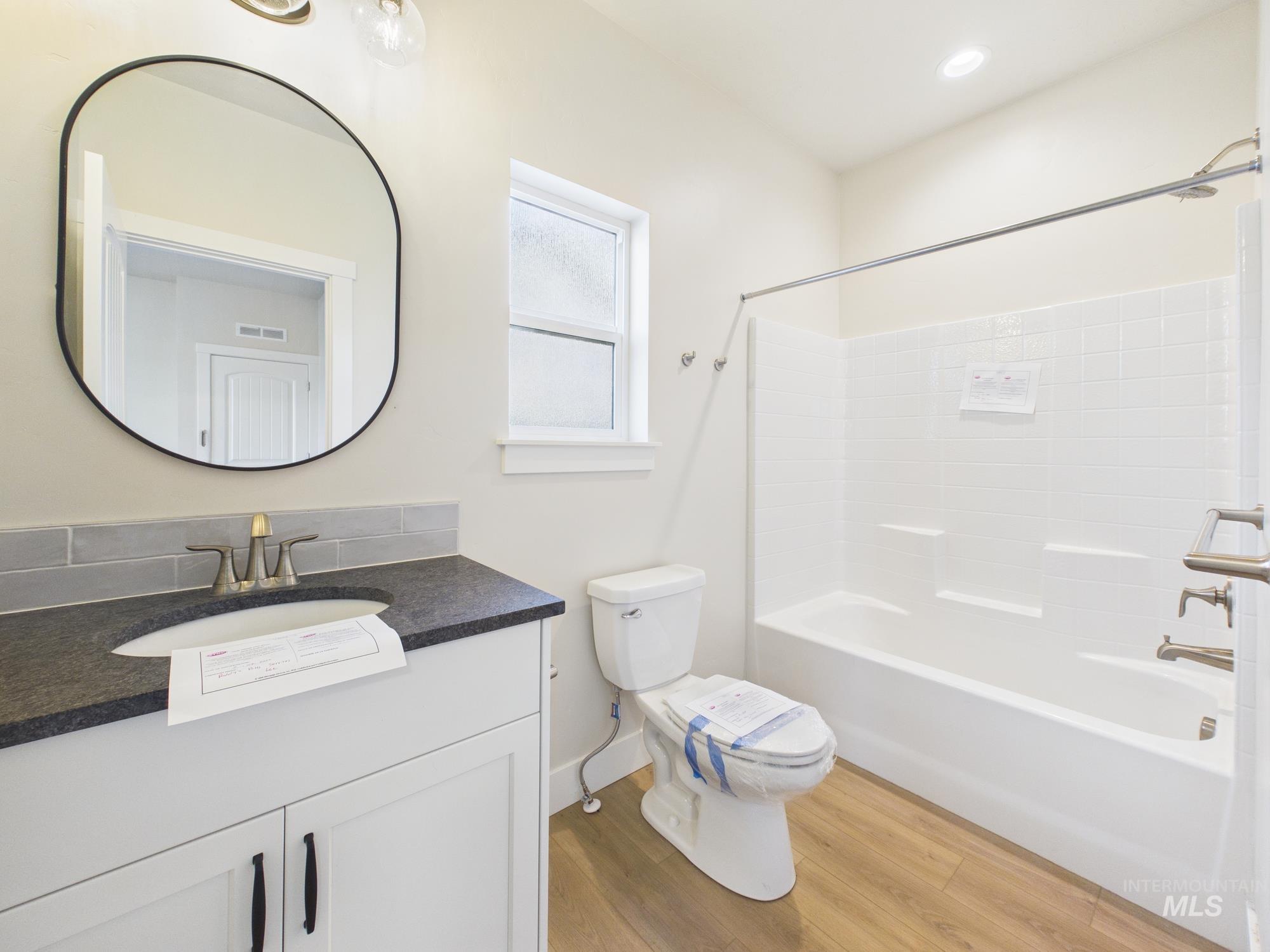 1545 Trail Way Weiser, ID 83672 - Photo 22 of 50 Bathroom with vanity, shower / washtub combination, and light wood-style floors