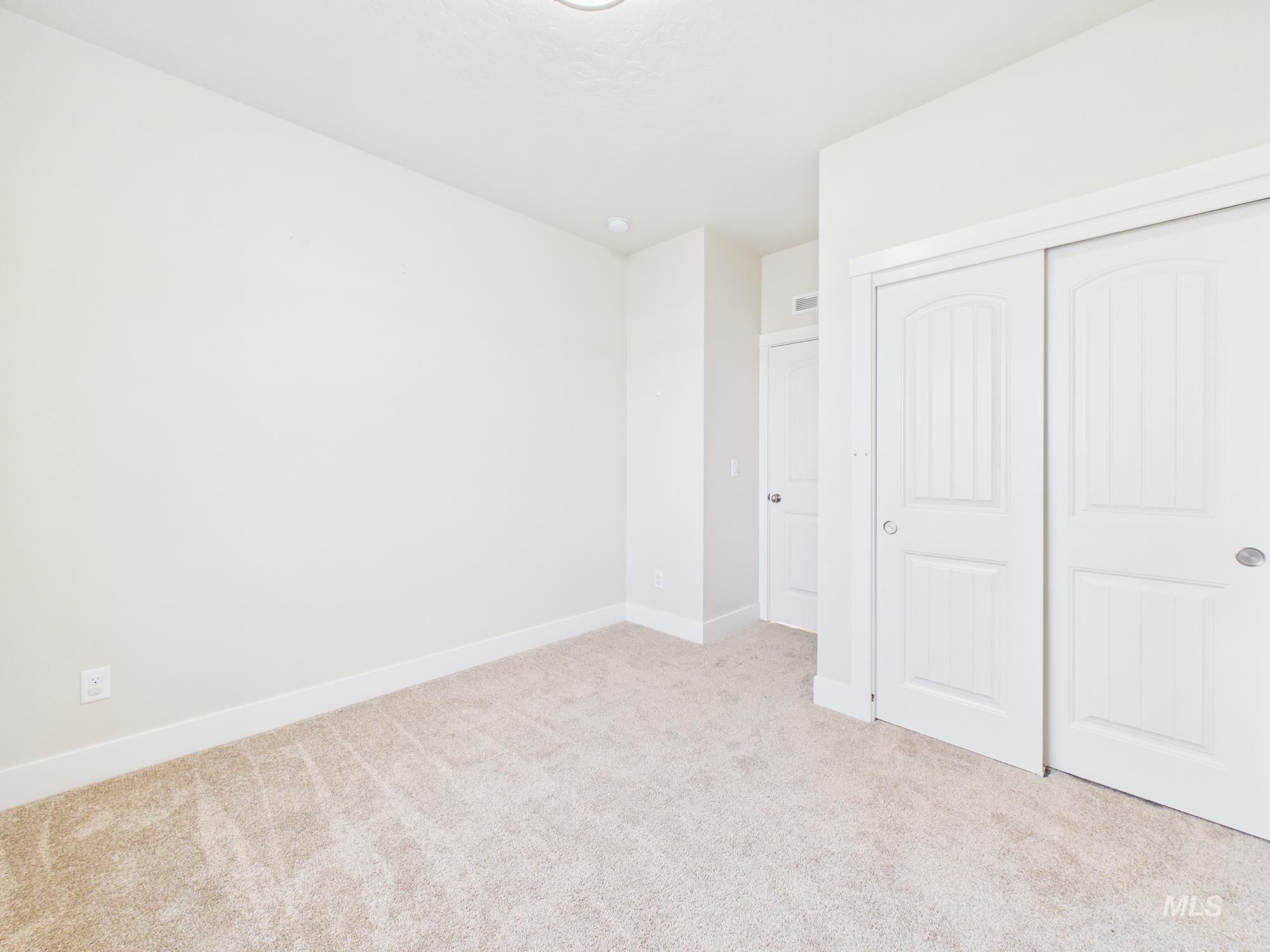 1545 Trail Way Weiser, ID 83672 - Photo 29 of 50 Unfurnished bedroom featuring light colored carpet and a closet