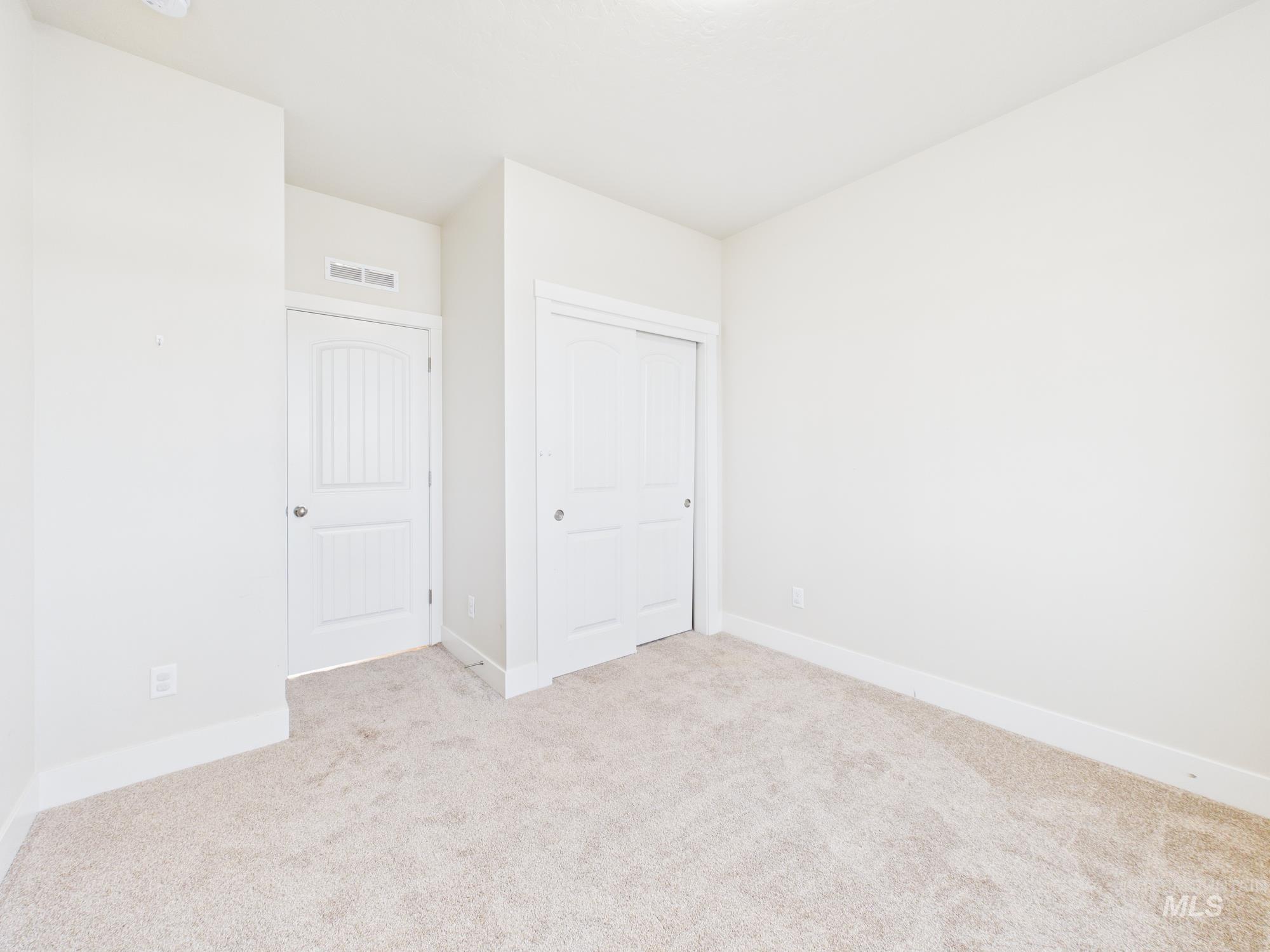 1545 Trail Way Weiser, ID 83672 - Photo 30 of 50 Unfurnished bedroom featuring light carpet and a closet