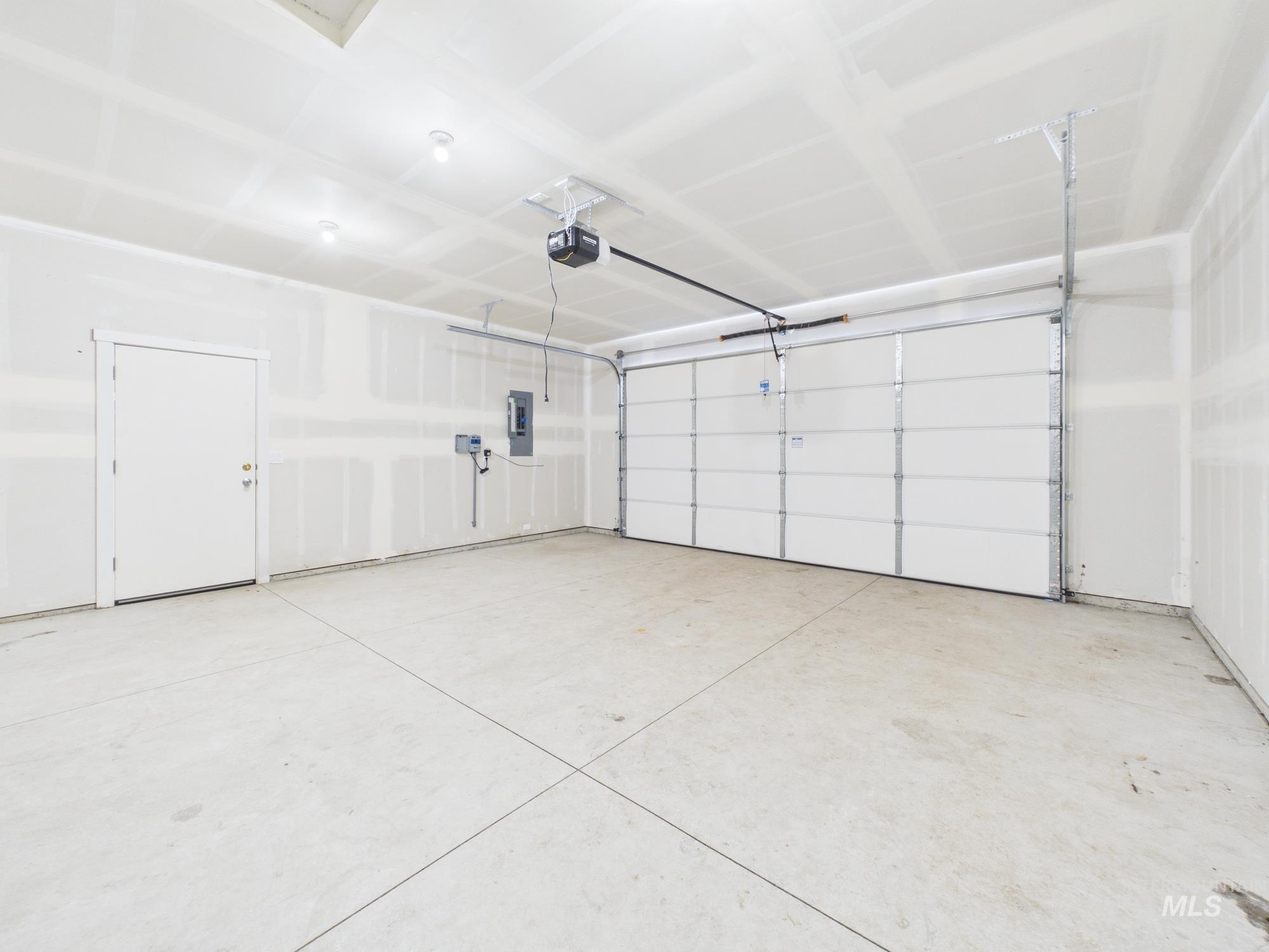 1545 Trail Way Weiser, ID 83672 - Photo 34 of 50 Garage with electric panel and a garage door opener
