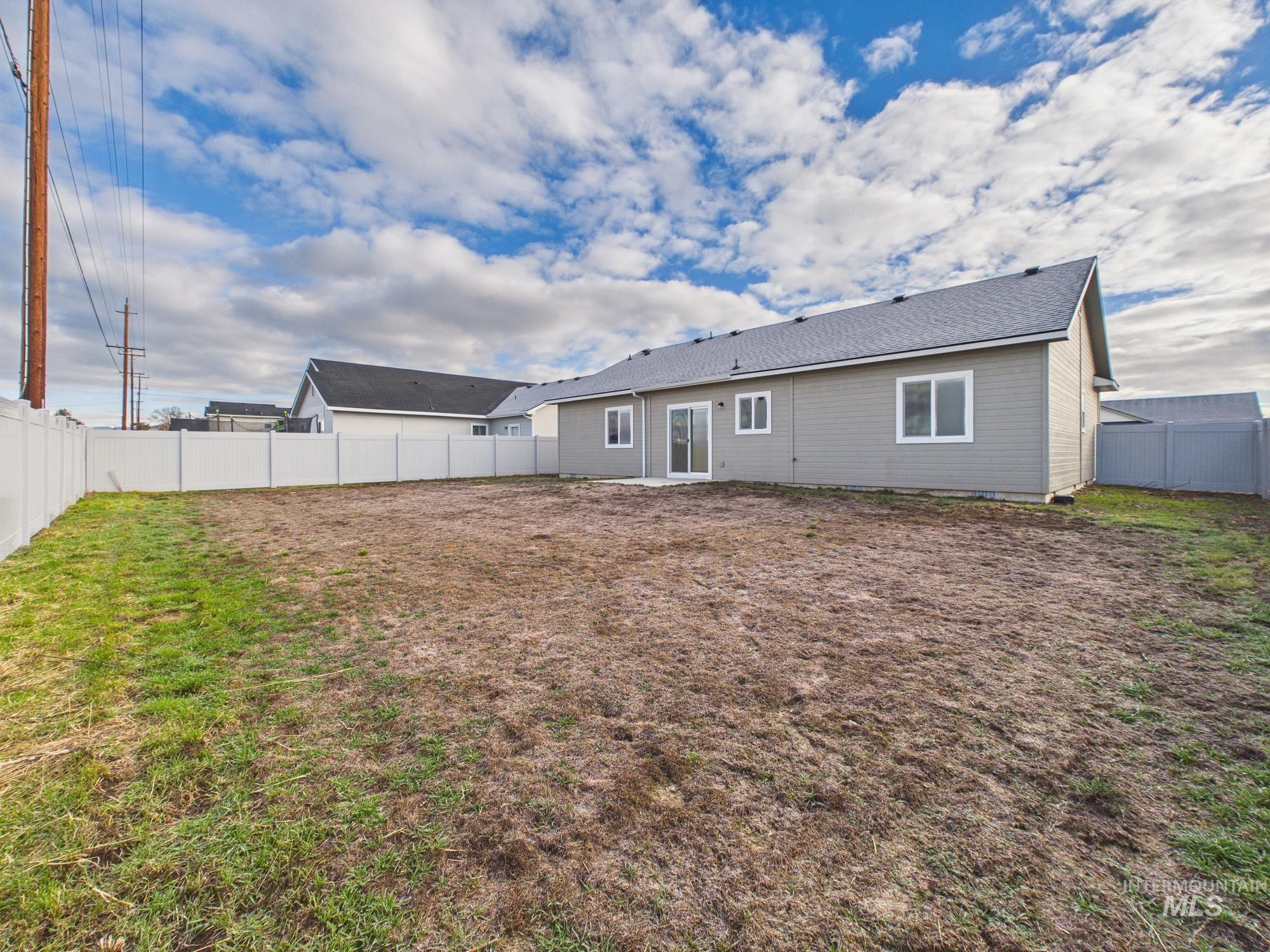 1545 Trail Way Weiser, ID 83672 - Photo 39 of 50 Rear view of house with a fenced backyard