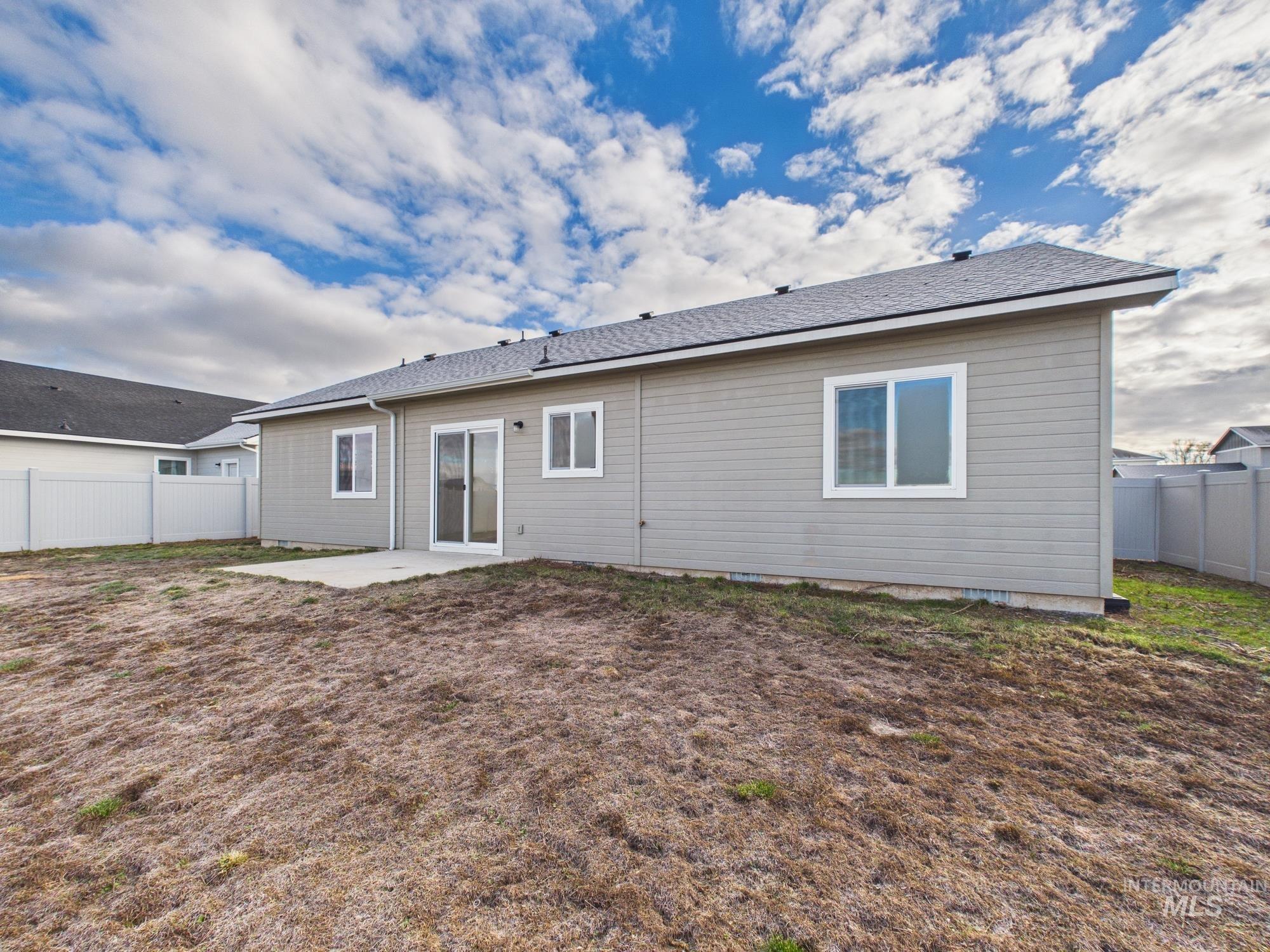 1545 Trail Way Weiser, ID 83672 - Photo 41 of 50 Back of property featuring a fenced backyard, a patio area, and roof with shingles