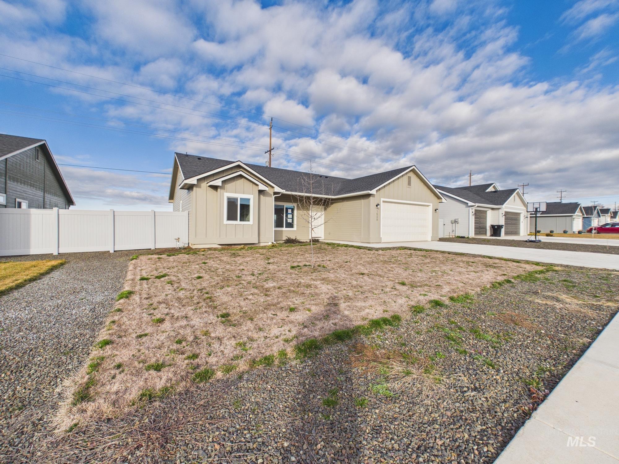 1545 Trail Way Weiser, ID 83672 - Photo 43 of 50 Single story home featuring an attached garage, driveway, board and batten siding, and roof with shingles