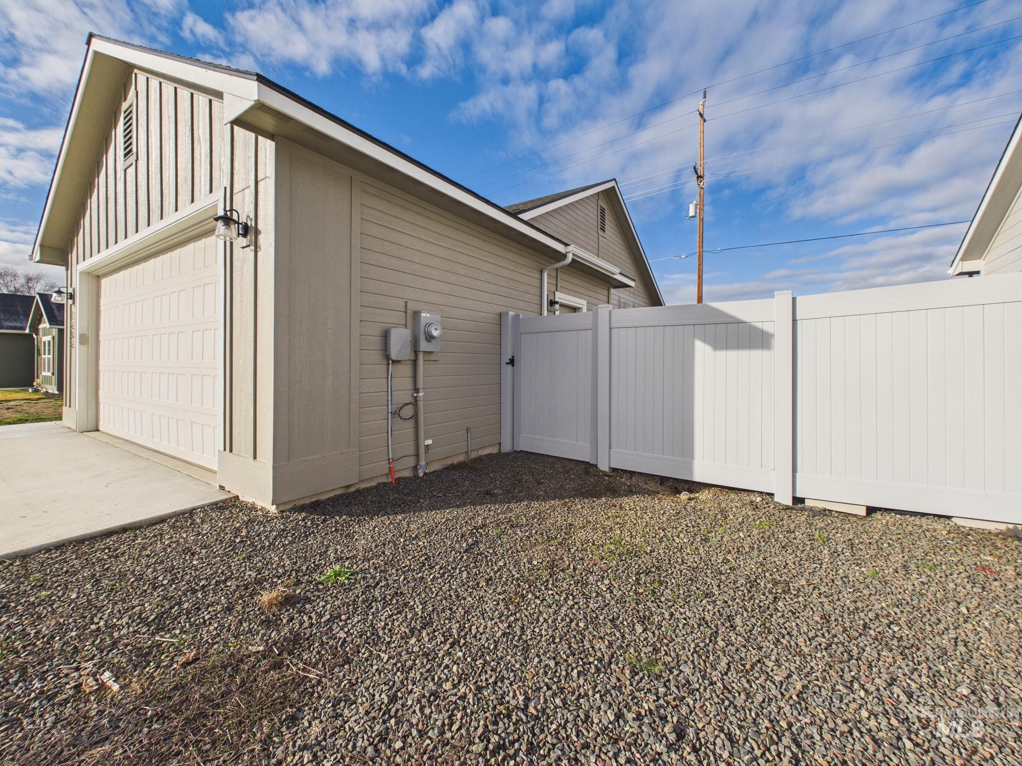 1545 Trail Way Weiser, ID 83672 - Photo 46 of 50 View of side of property featuring a garage, board and batten siding, an outbuilding, and driveway