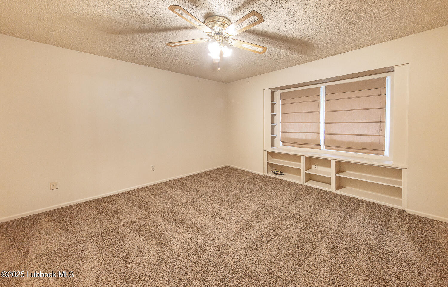5750 38th Street Lubbock, TX 79407 - Photo 15 of 24 a view of a livingroom with a ceiling fan and window