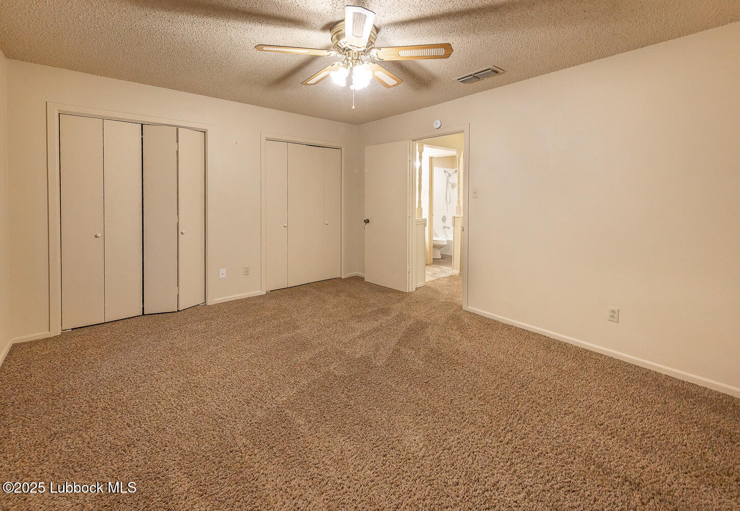 5750 38th Street Lubbock, TX 79407 - Photo 16 of 24 en empty room with windows and fan