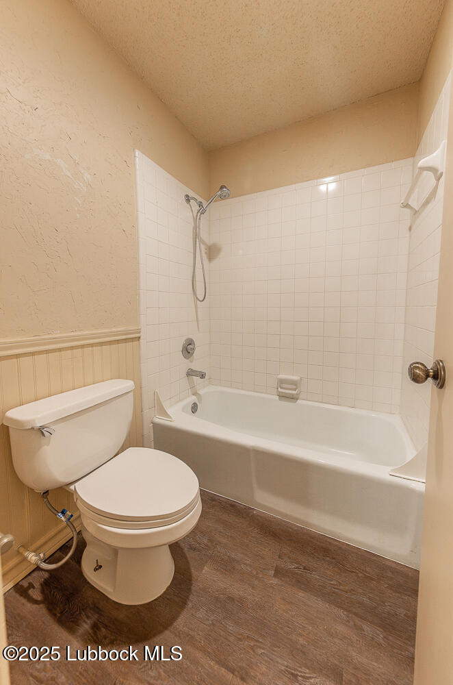 5750 38th Street Lubbock, TX 79407 - Photo 18 of 24 a bathroom with a toilet and a bath tub