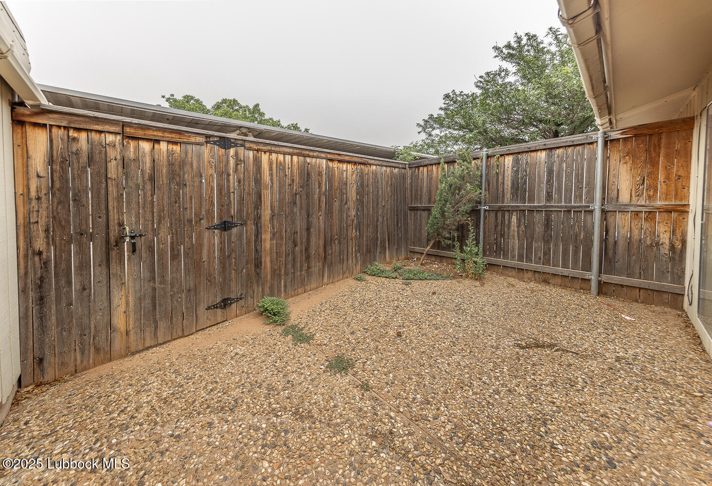 5750 38th Street Lubbock, TX 79407 - Photo 21 of 24 a backyard of a house with table and chairs