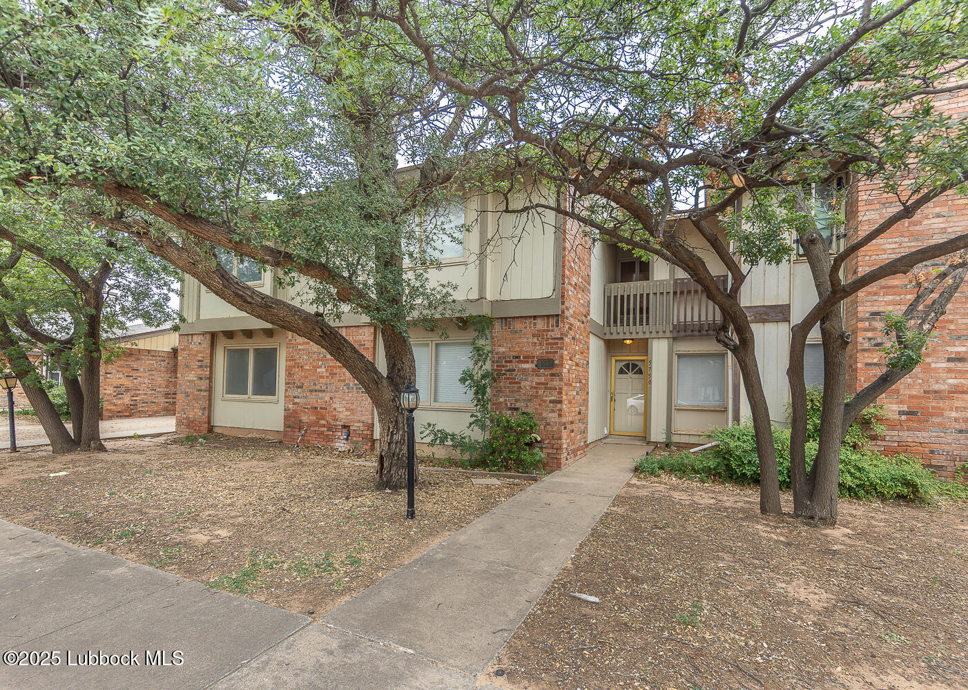 5750 38th Street Lubbock, TX 79407 - Photo 24 of 24 a front view of a house with a yard and large trees