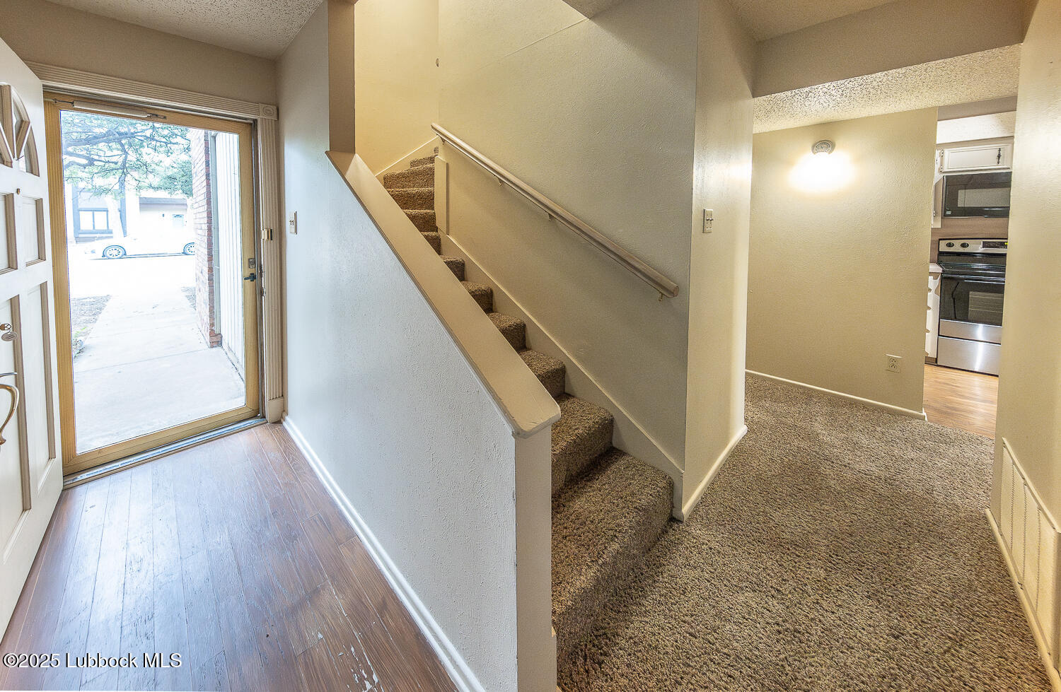 5750 38th Street Lubbock, TX 79407 - Photo 5 of 24 a view of entryway and hall with wooden floor