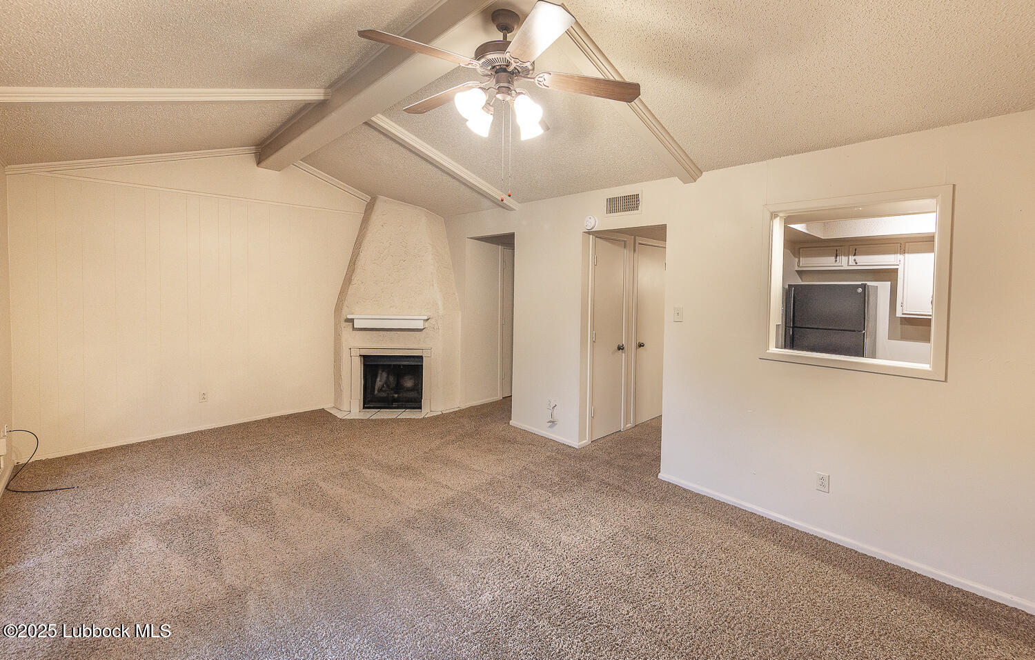 5750 38th Street Lubbock, TX 79407 - Photo 8 of 24 an empty room with a ceiling fan and entryway