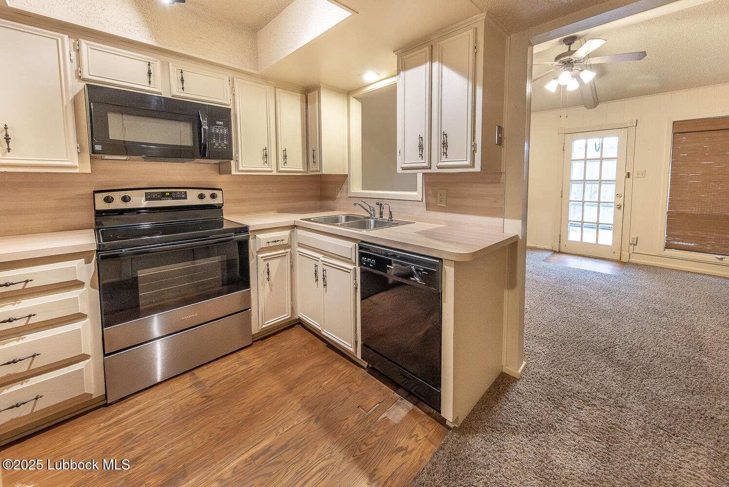 5750 38th Street Lubbock, TX 79407 - Photo 10 of 24 a kitchen with a stove and a microwave