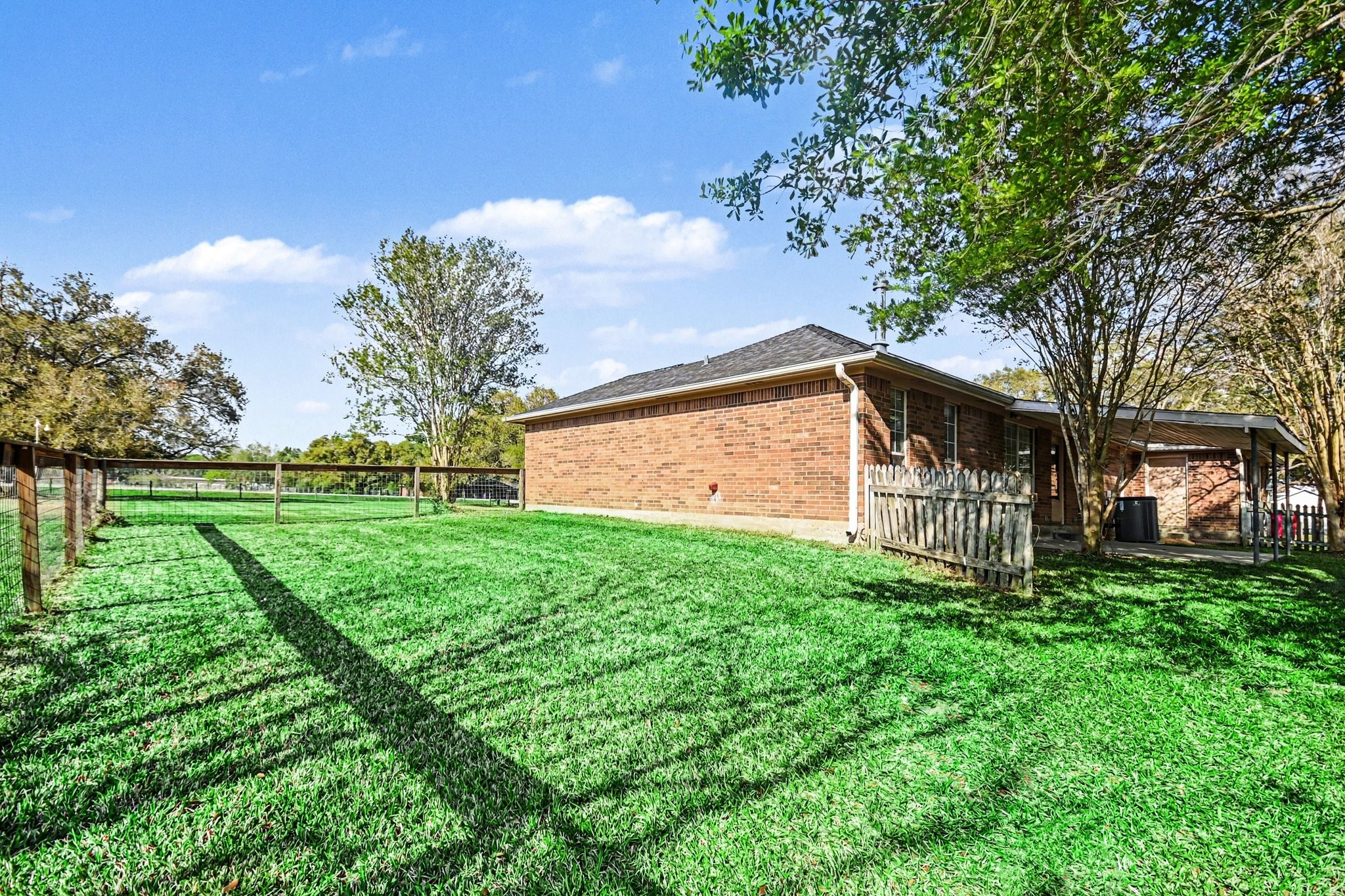 21503 Pecan Bend Road Damon, TX 77430 - Photo 29 of 45 a view of a backyard with large trees