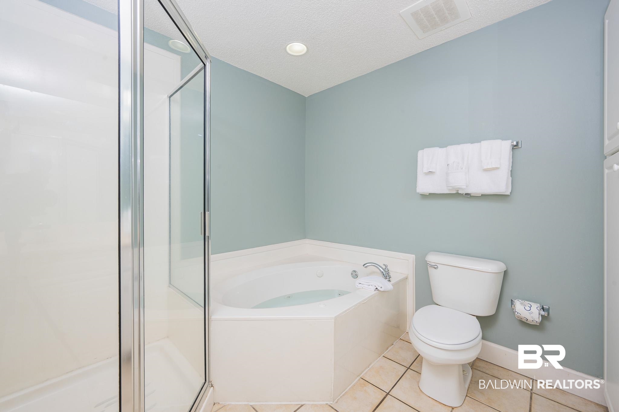 27580 Canal Road, Unit 1322 Orange Beach, AL 36561 - Photo 15 of 30 Full bathroom featuring a garden tub, a shower stall, tile patterned flooring, and a textured ceiling