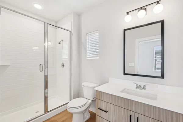 a bathroom with a sink toilet and shower