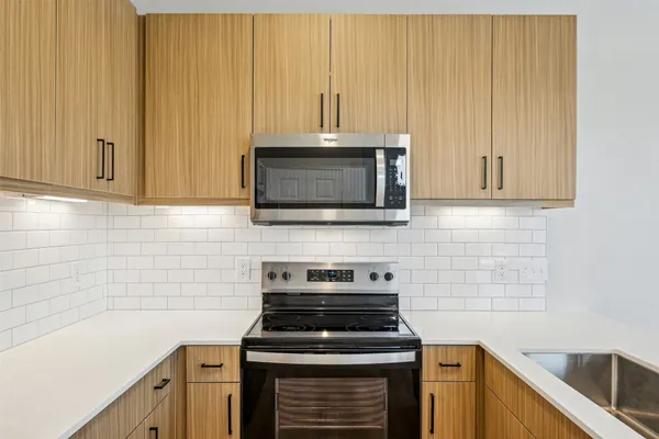 a kitchen with microwave cabinets and stainless steel appliances