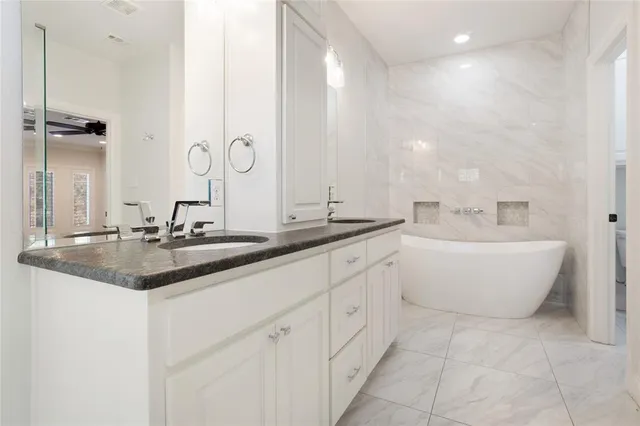 a bathroom with a double vanity sink and a mirror