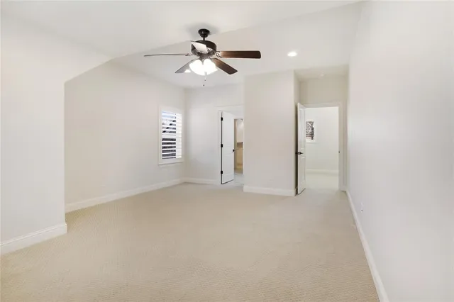a view of empty room with ceiling fan