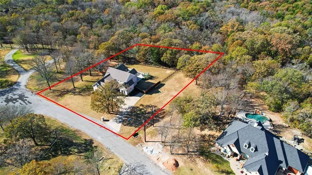 a view of a yard with large trees