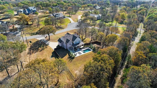 a view of a patio with table and chairs under an umbrella