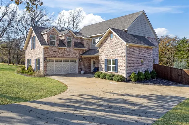 a front view of a house with a garden and entryway