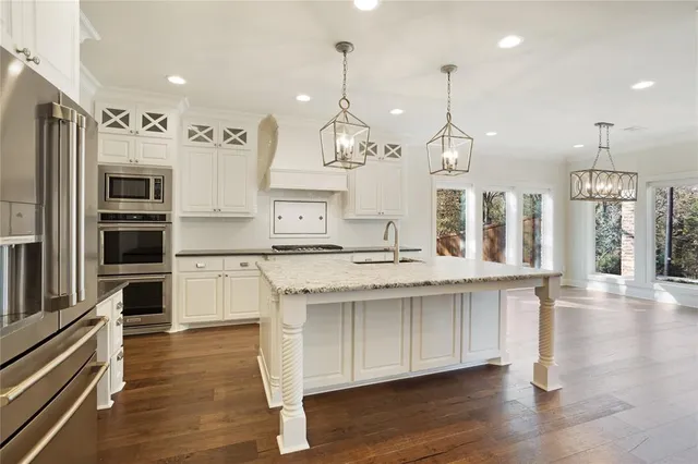 a kitchen with counter top space and wooden floor