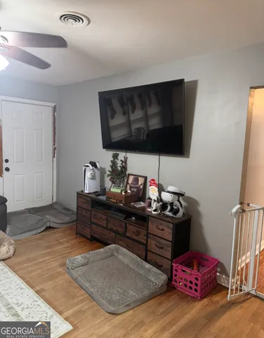 a kitchen with a sink and a stove with wooden floor