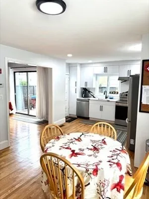 a bed sitting in a kitchen next to a large window