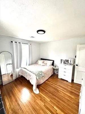 a bedroom with a bed and a large mirror