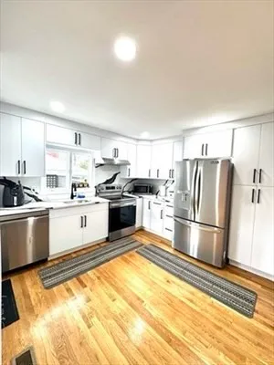 a kitchen with stainless steel appliances granite countertop a refrigerator sink and stove