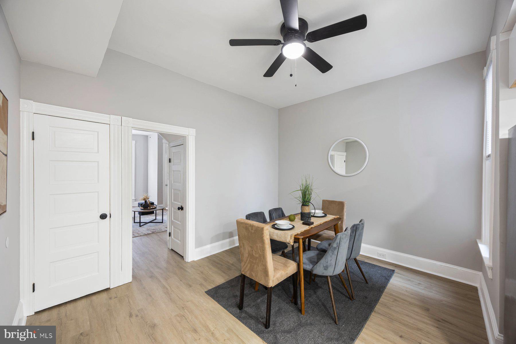 3611 Chestnut Avenue Baltimore, MD 21211 - Photo 11 of 38 a dining room with furniture a chandelier and wooden floor