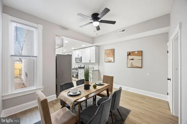 a view of a dining room with furniture window and wooden floor