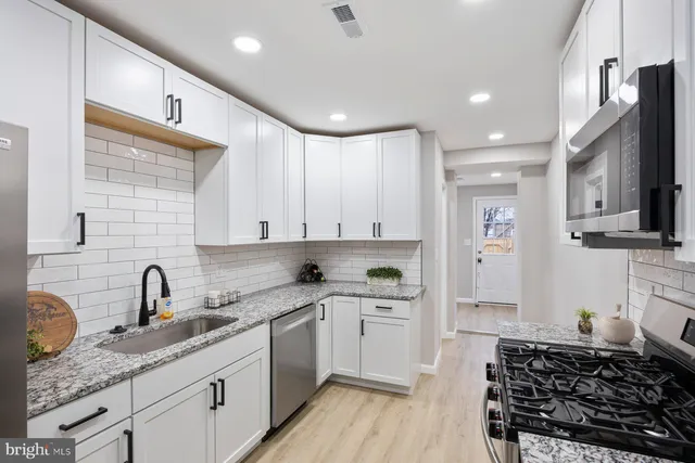 a kitchen with a sink stove and cabinets